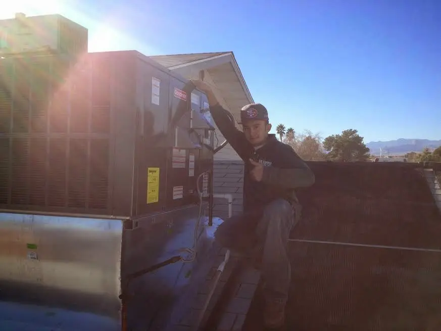 HVAC technician performing HVAC Inspection on a rooftop unit in Tolland